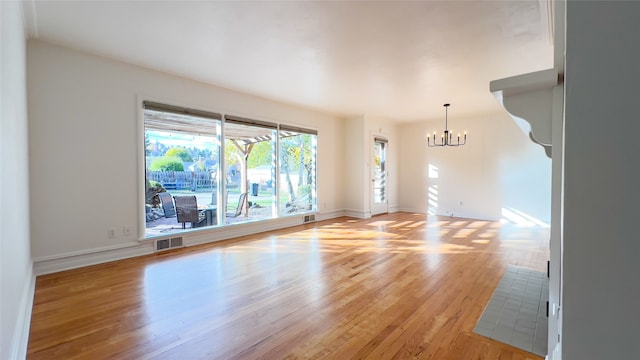 interior space featuring light hardwood / wood-style flooring and an inviting chandelier