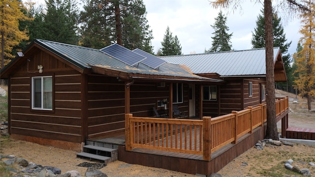 rear view of house with a wooden deck