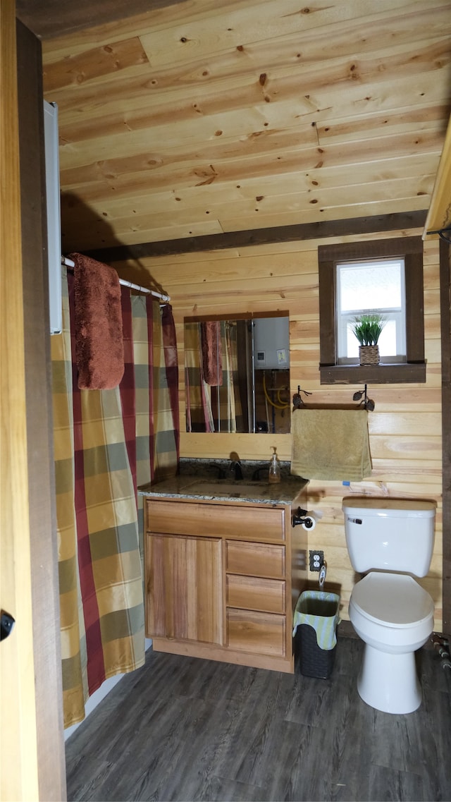 bathroom with toilet and wood walls