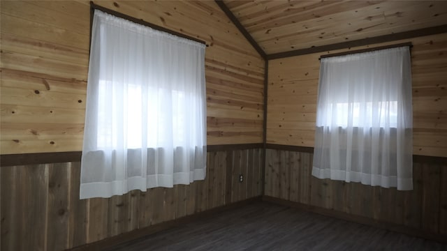 unfurnished room with wood ceiling, wooden walls, dark wood-type flooring, and vaulted ceiling