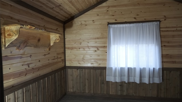 unfurnished room with wood ceiling, wood-type flooring, lofted ceiling, and wooden walls