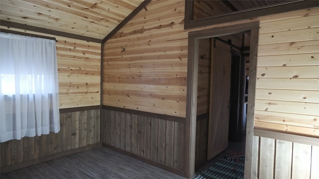 unfurnished room with wooden walls, vaulted ceiling, wooden ceiling, and dark hardwood / wood-style flooring