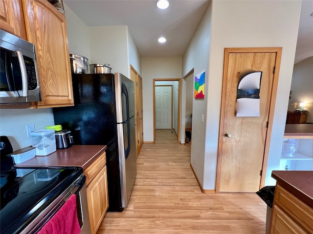 kitchen featuring black range with electric cooktop and light wood-type flooring