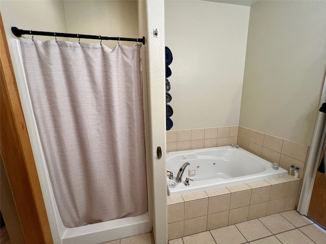 bathroom with tiled tub and tile patterned flooring