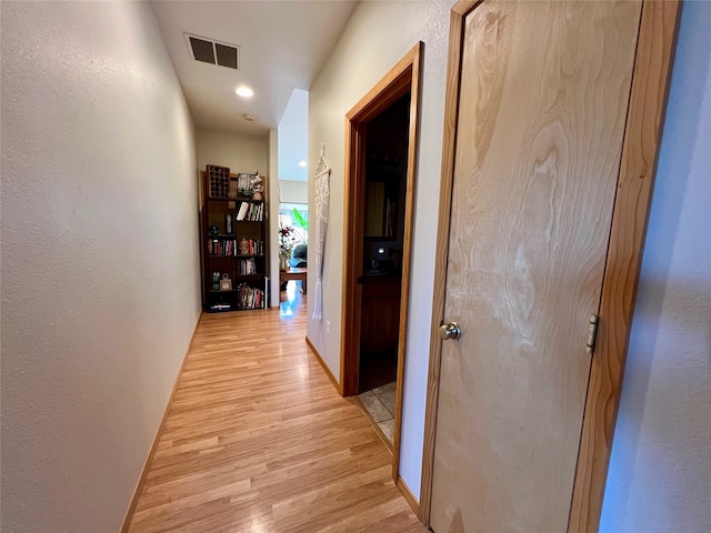 hall with light hardwood / wood-style flooring