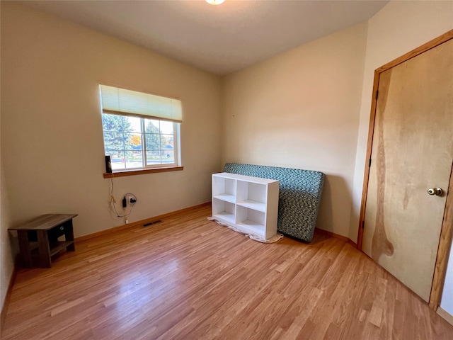 unfurnished bedroom with light hardwood / wood-style flooring and a closet