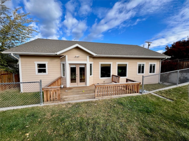 rear view of property with french doors and a yard