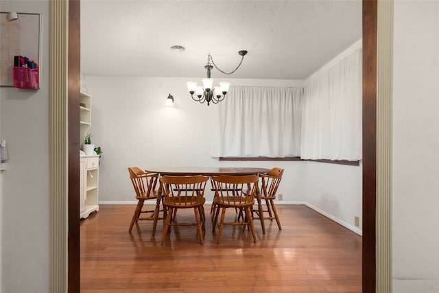 dining area featuring a notable chandelier and hardwood / wood-style floors