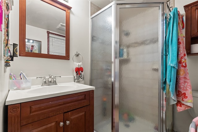 bathroom featuring vanity and an enclosed shower