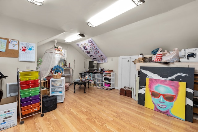 recreation room with lofted ceiling and light wood-type flooring