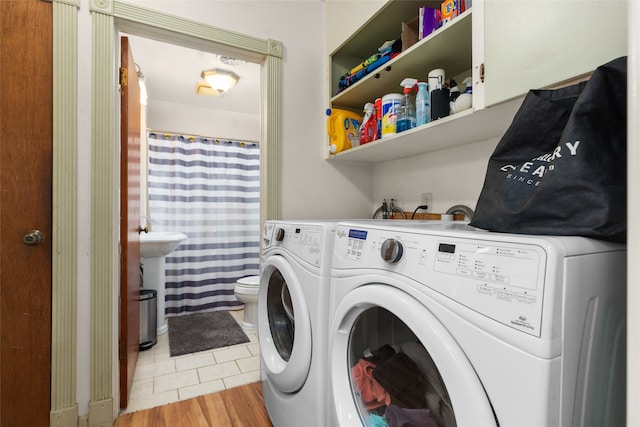 laundry area featuring light hardwood / wood-style flooring and washer and dryer