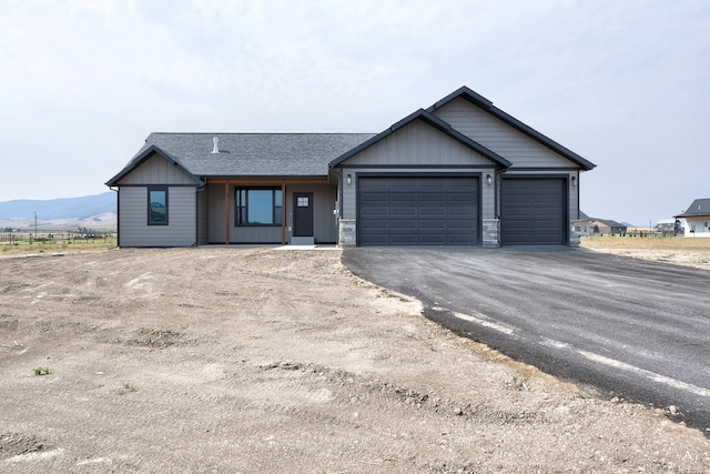 view of front of house featuring a garage and a mountain view