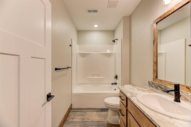 full bathroom with tub / shower combination, hardwood / wood-style floors, toilet, and vanity