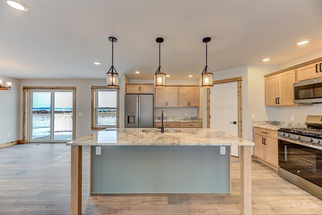 unfurnished living room with ceiling fan and light hardwood / wood-style flooring