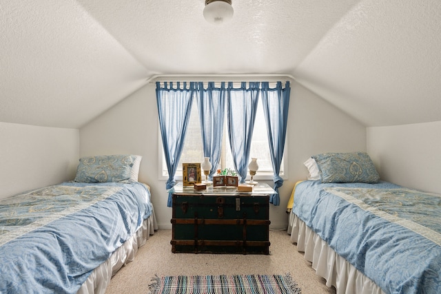 bedroom featuring a textured ceiling, vaulted ceiling, and light colored carpet