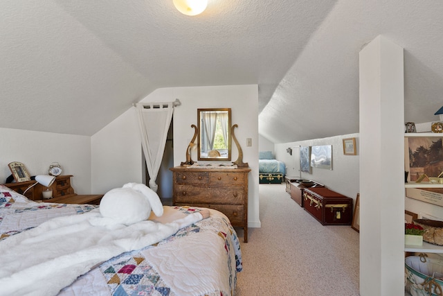 bedroom featuring lofted ceiling, a textured ceiling, and carpet flooring