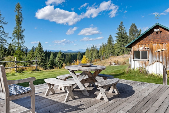 wooden deck featuring a lawn