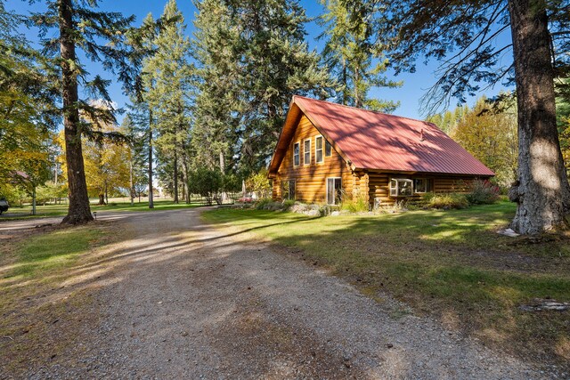 view of property exterior featuring a lawn