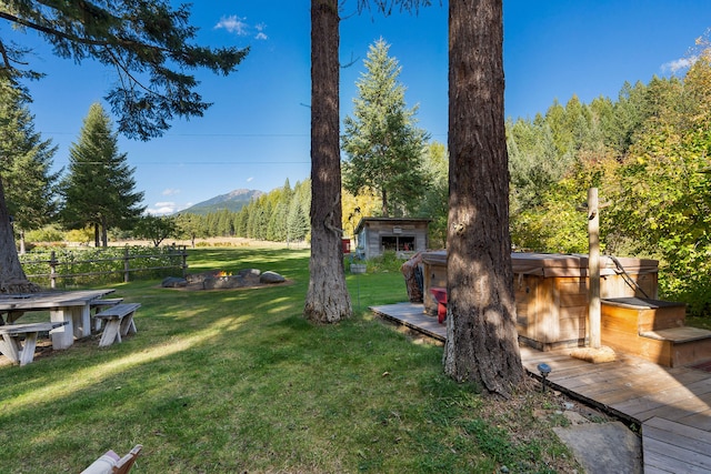 view of yard with a deck with mountain view