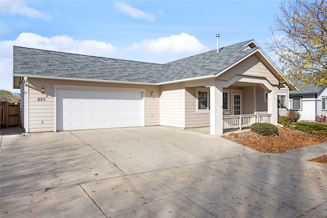 ranch-style home with covered porch and a garage