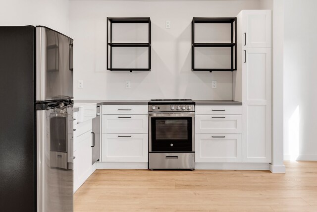 kitchen featuring light hardwood / wood-style floors, stainless steel appliances, and white cabinets