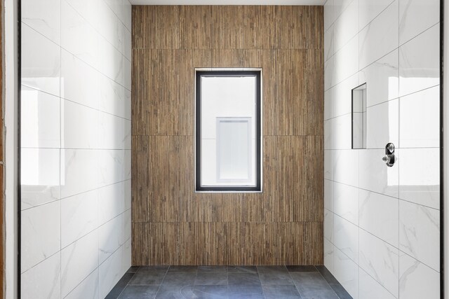 spare room featuring tile walls