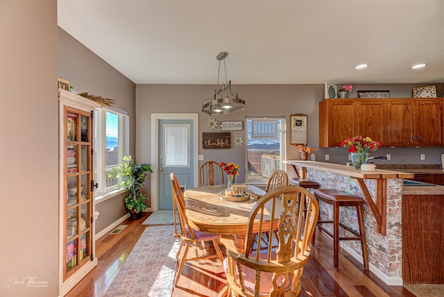 dining area with an inviting chandelier and light wood-type flooring