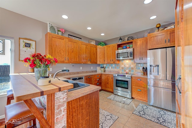 4349 Stoney Rd, Helena, MT 59602 - kitchen with stainless steel appliances, light countertops, a peninsula, healthy amount of natural light, and recessed lighting