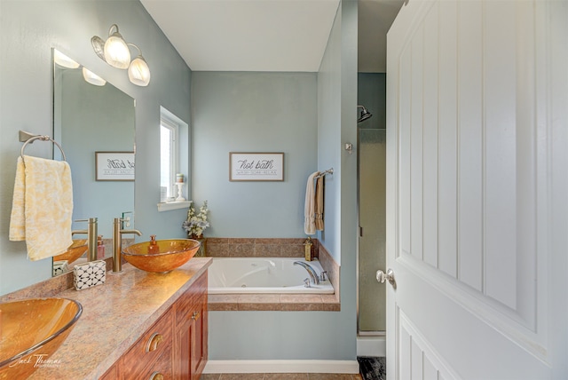 bathroom featuring vanity and shower with separate bathtub