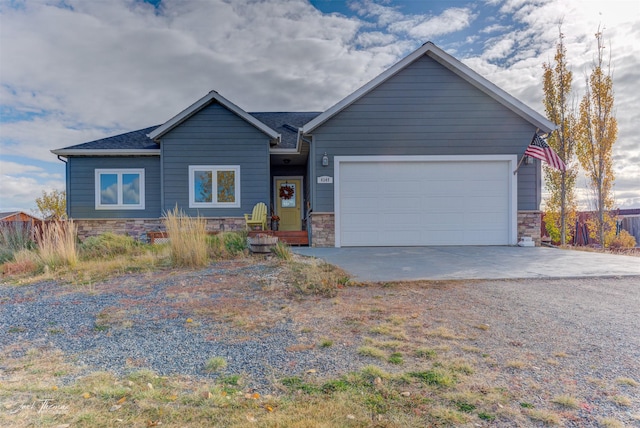 4349 Stoney Rd, Helena, MT 59602 - view of front of house featuring stone siding, concrete driveway, and a garage