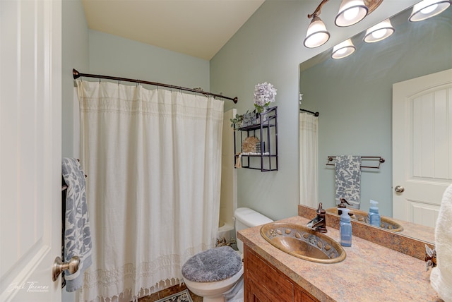 full bathroom with vanity, shower / tub combo, and toilet