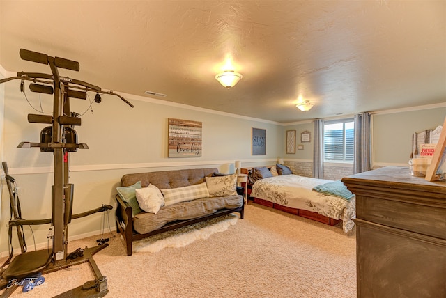 bedroom with a textured ceiling, carpet, and ornamental molding