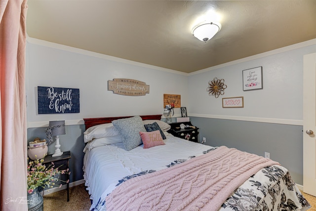 bedroom with crown molding and carpet floors