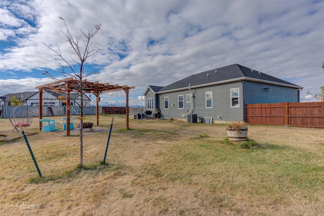 4349 Stoney Rd, Helena, MT 59602 - rear view of property featuring a pergola, central AC unit, an outdoor fire pit, and a shingled roof