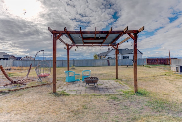 view of yard featuring a pergola, a patio, and a fire pit