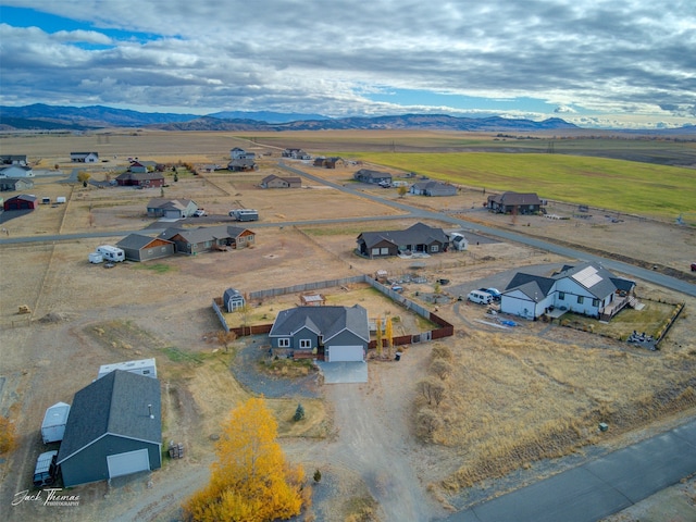 birds eye view of property with a mountain view and a rural view