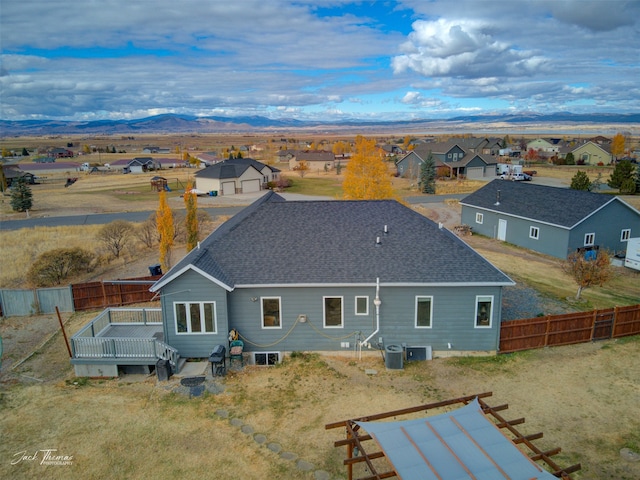 back of house with a mountain view and cooling unit