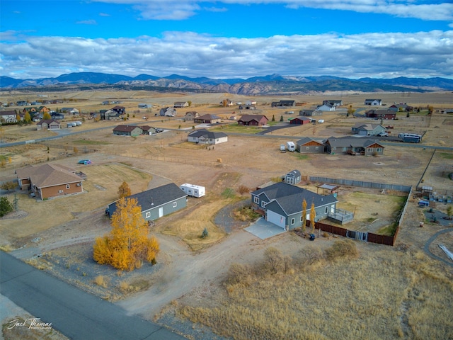 birds eye view of property with a mountain view