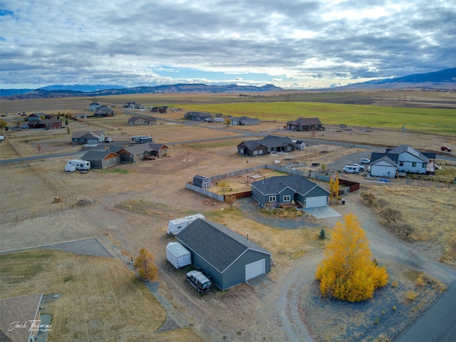 drone / aerial view featuring a mountain view and a rural view