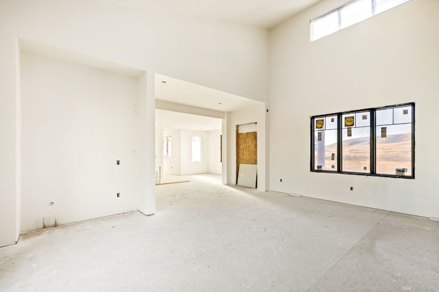 unfurnished room with a towering ceiling