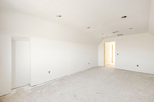 unfurnished room featuring lofted ceiling