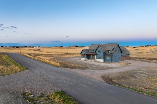 exterior space featuring a garage and a rural view