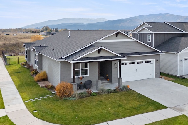 view of front of home with a mountain view and a front yard