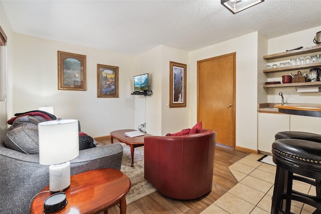 180 Vista Ln Unit 137, Bigfork, MT 59911 - living room featuring wet bar, light wood-type flooring, and a textured ceiling