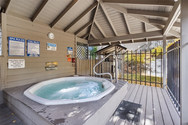 view of swimming pool featuring a wooden deck and an indoor in ground hot tub