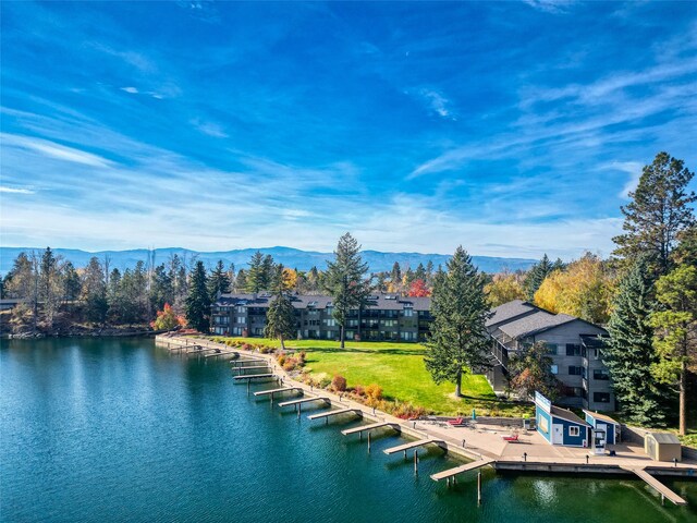 drone / aerial view featuring a water and mountain view