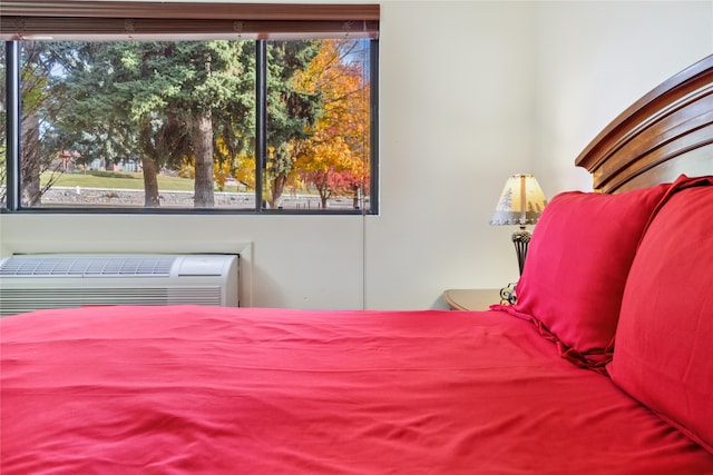 bedroom featuring a wall mounted air conditioner