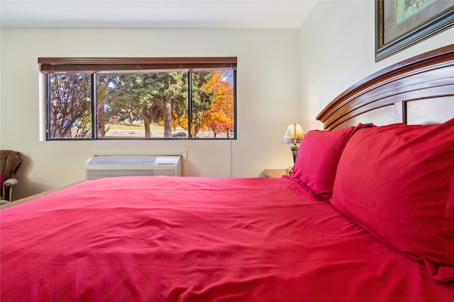 bedroom featuring a wall unit AC