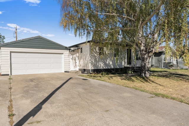 view of front of house with a garage and a front lawn