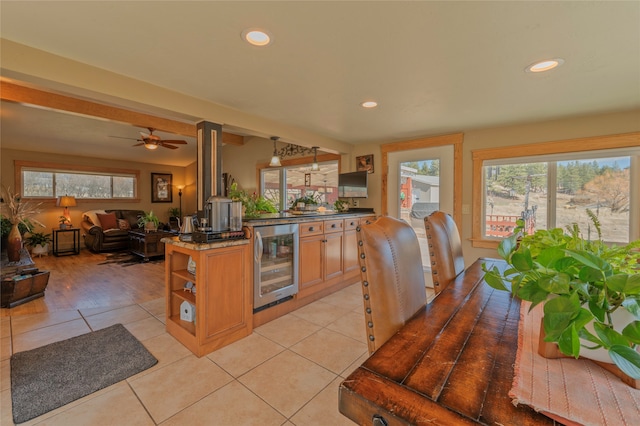 kitchen featuring ceiling fan, beverage cooler, and light tile patterned floors